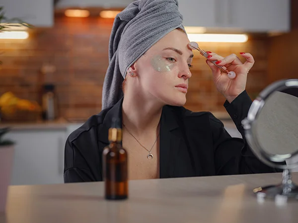 Woman using face roller Woman using face roller